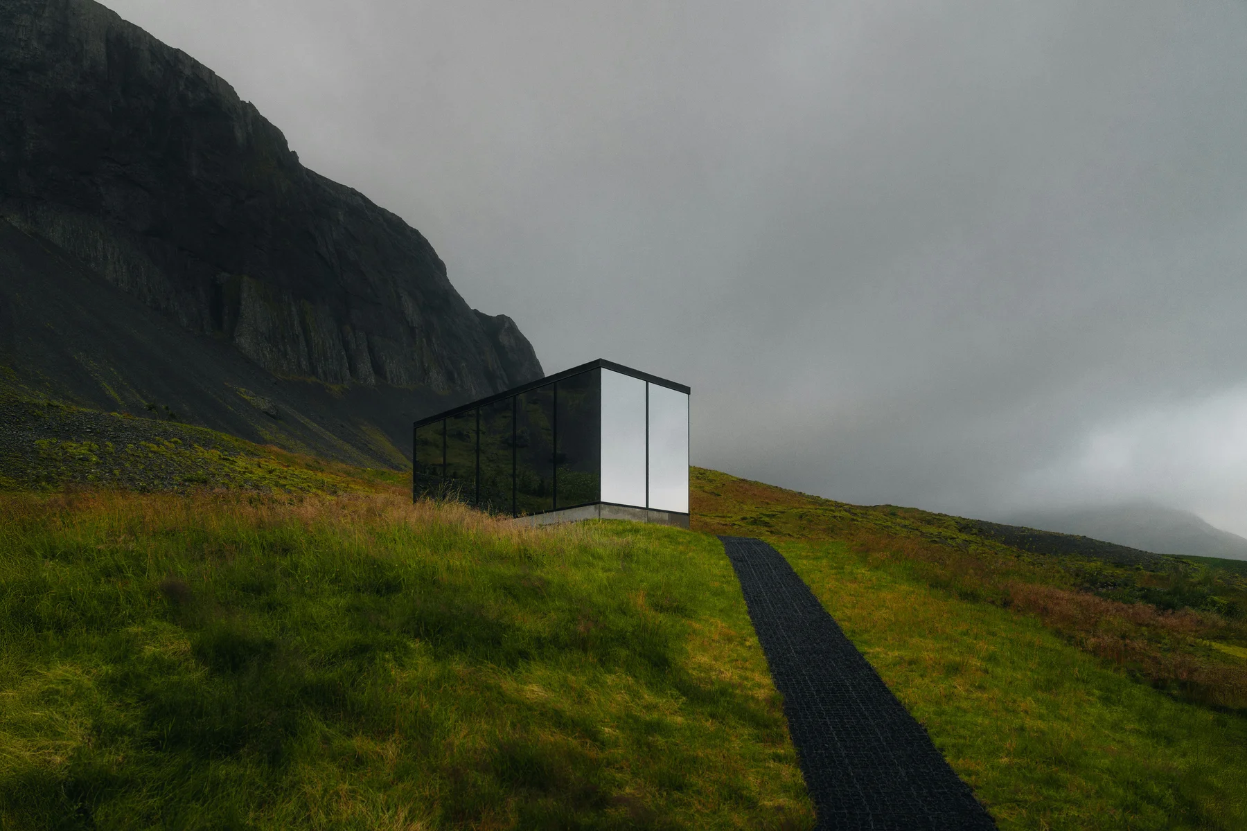 A contemporary home set into a green hillside