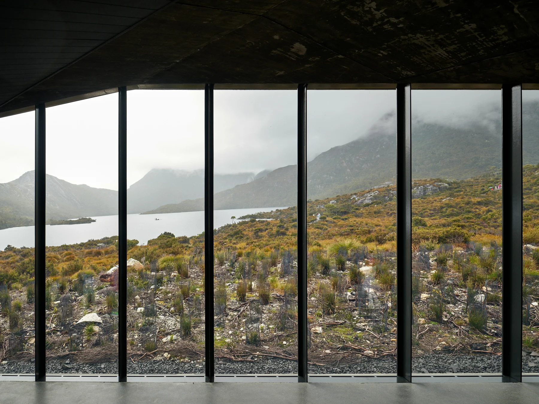 A quiet coastal view framed by a home's windows